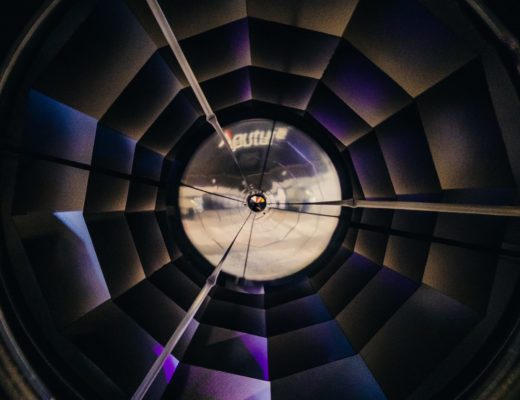 Looking directly into a parabolic reflector with the faceted mirrors visible.