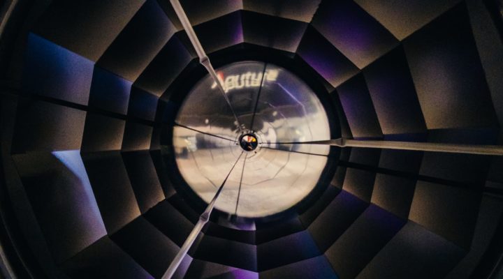Looking directly into a parabolic reflector with the faceted mirrors visible.