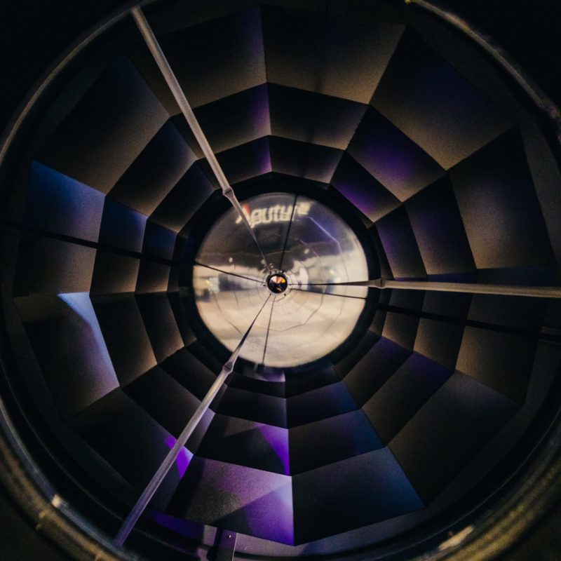 Looking directly into a parabolic reflector with the faceted mirrors visible.