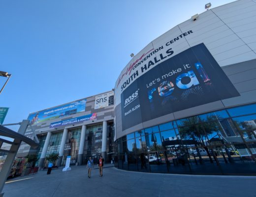 A wide angle view looking up at the South Hall of the Las Vegas Convention Center, showing hoardings advertising exhibitors at the 2025 NAB Show.