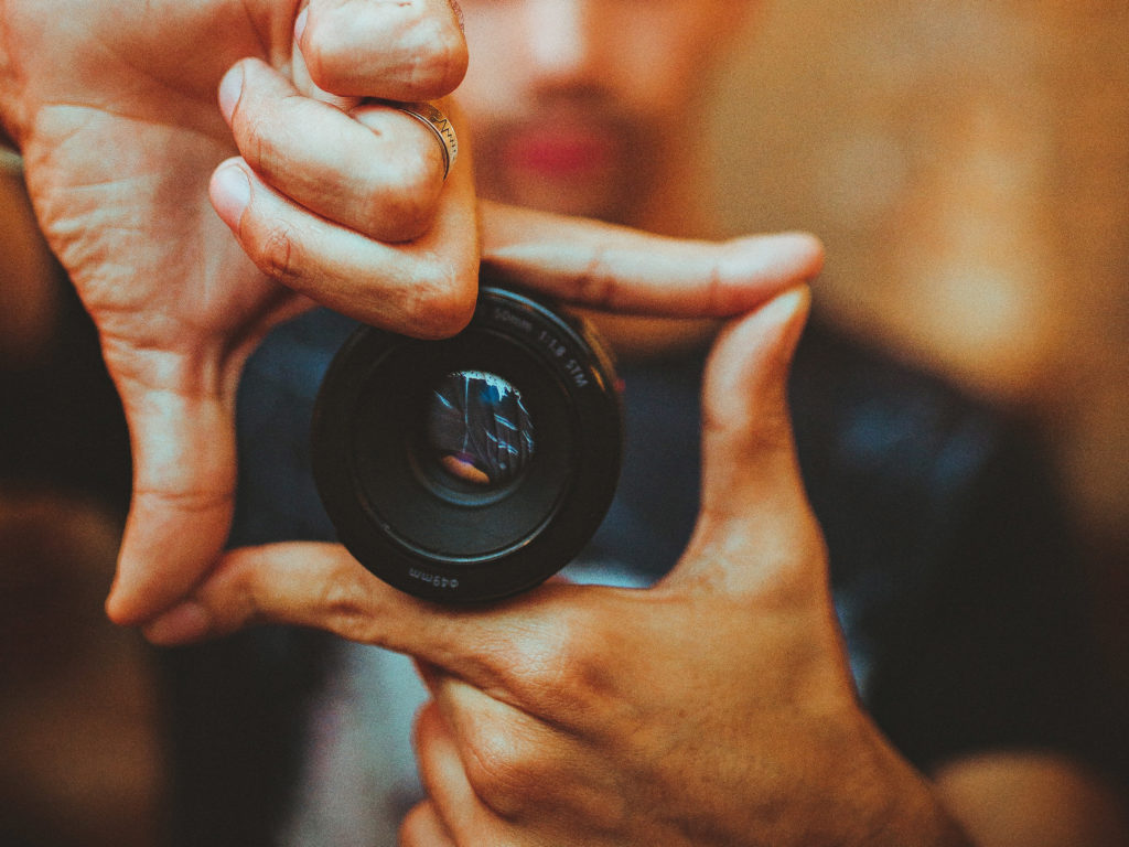 A photographer marking a frame with his fingers