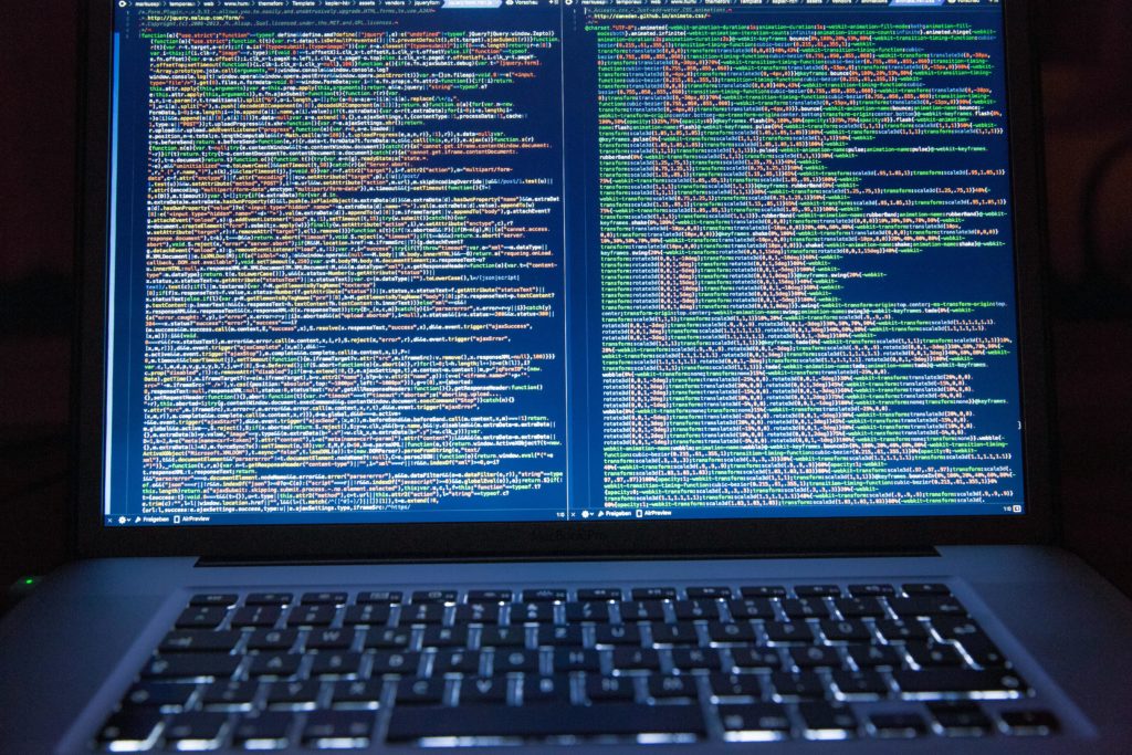 A laptop displaying closely packed lines of computer code.