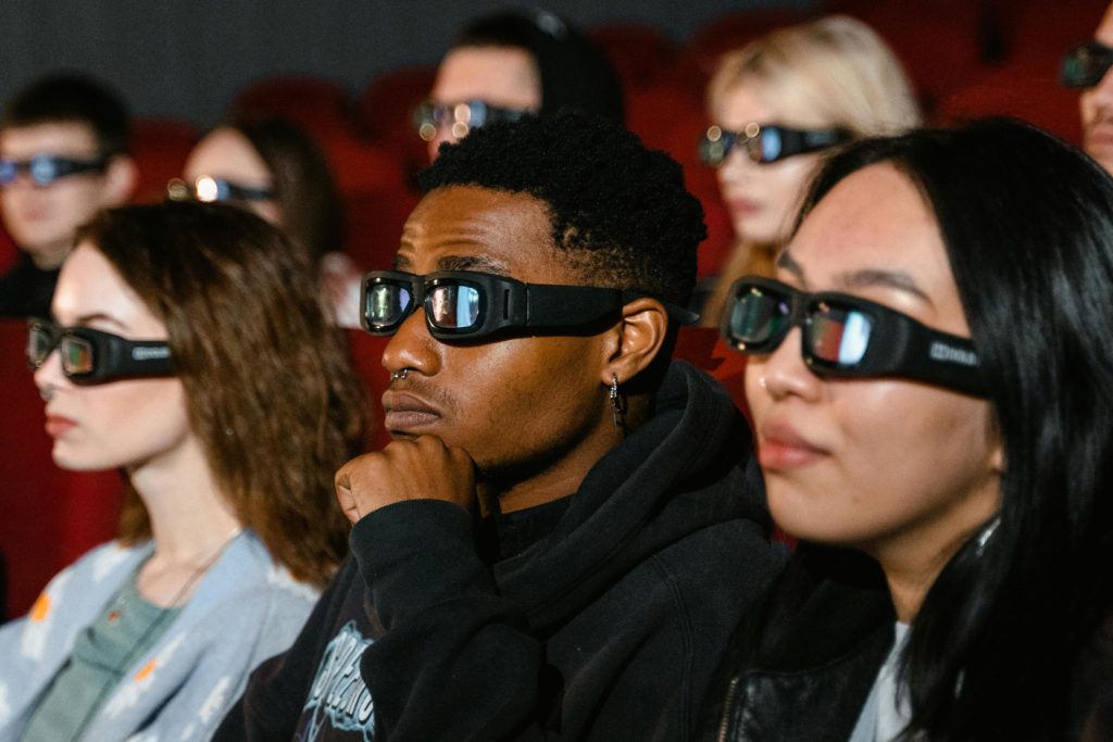 Cinema audience wearing 3D glasses.