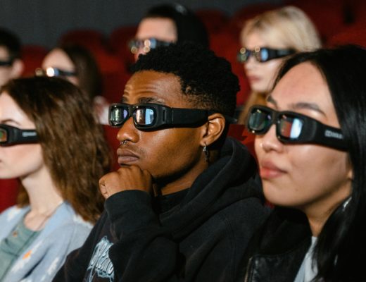 Cinema audience wearing 3D glasses.